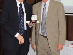 Ian Young hands ADB Medal to Michael Roe, 2012
