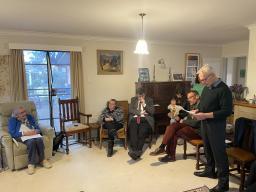 A man delivering a speech in front of a group of people.