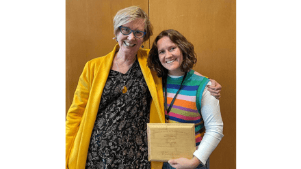 Nancy Jacobs and Jess Urwin holding a plaque