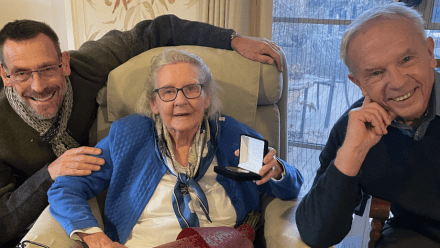 Three people smiling for the camera
