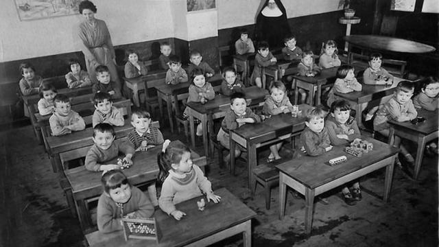 children in class with teacher and nun