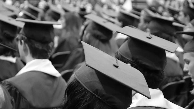 black and white image of graduates in hats and gowns